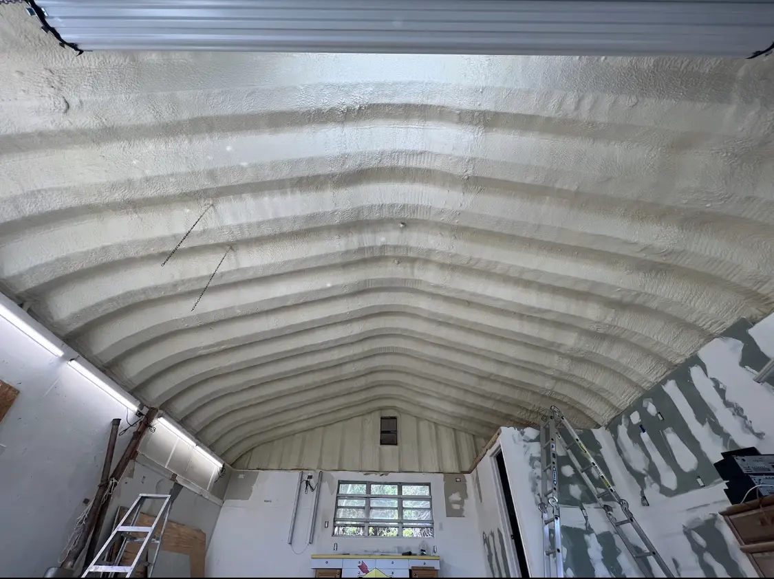 Spray polyurethane foam applied to the underside of a metal roof deck in Warrensburg